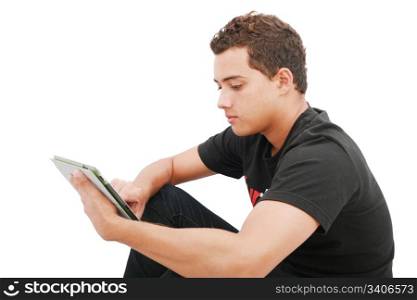 School boy with electronic tablet sitting in the floor
