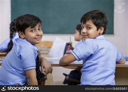 school boys sitting  in class and smiling