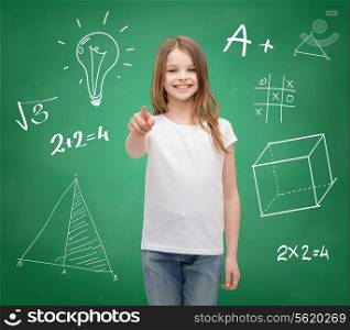school, childhood, gesture and education concept - smiling little girl in white blank t-shirt pointing on you