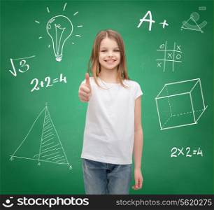 school, childhood, gesture and education concept - smiling little girl in white blank t-shirt showing thumbs up