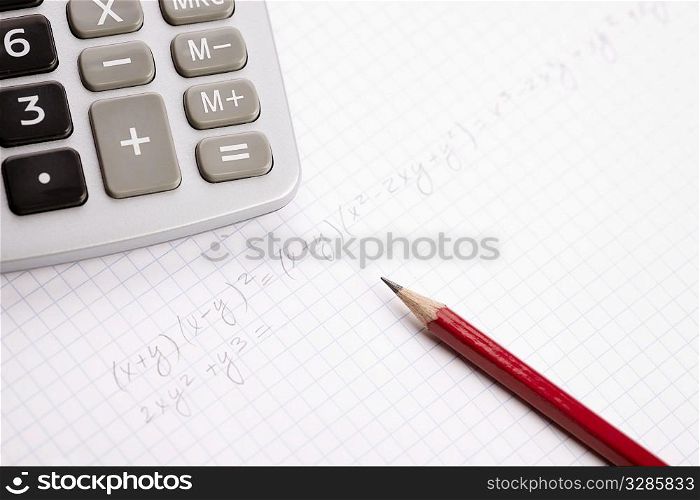 school concept, pencil and calculator in closeup, selective focus