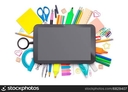 School concept. Tablet over school supplies isolated on white background. Top view