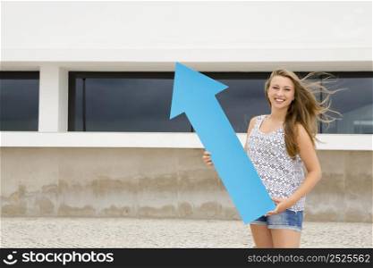 School concept - Teenage student holding a blue arrows