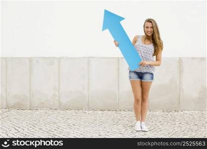 School concept - Teenage student holding a blue arrows