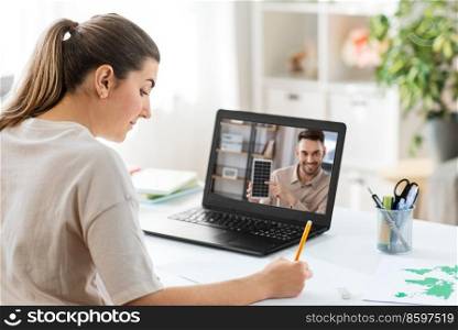 school, education and distance learning concept - female student with teacher on laptop computer screen having video call or online class at home. student with laptop having online class at home