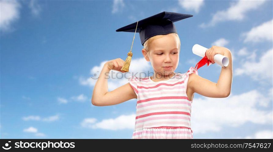 school, education and learning concept - happy little girl in bachelor hat or mortarboard with diploma over blue sky and clouds background. little girl in mortarboard with diploma