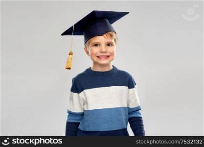 school, education and learning concept - little boy in bachelor hat or mortarboard. little boy in bachelor hat or mortarboard