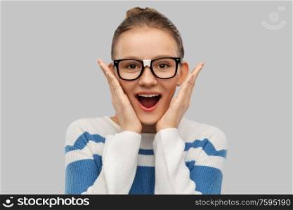school, education and vision concept - surprised teenage student girl in taped glasses over grey background. surprised teenage student girl in taped glasses
