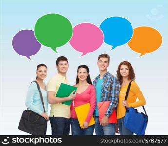 school, education, communication and people concept - group of smiling students with folders and school bags over blue background with text bubbles