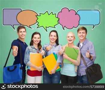 school, education, communication and people concept - group of smiling teenagers with folders and school bags showing thumbs up over green board background with text bubbles