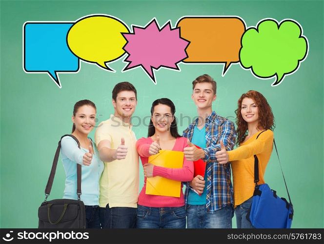 school, education, communication, gesture and people concept - group of smiling students with folders and school bags showing thumbs up over green board background with text bubbles