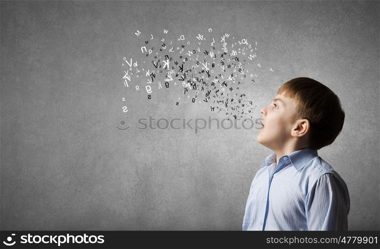 School education. Cute boy of school age and letters flying around