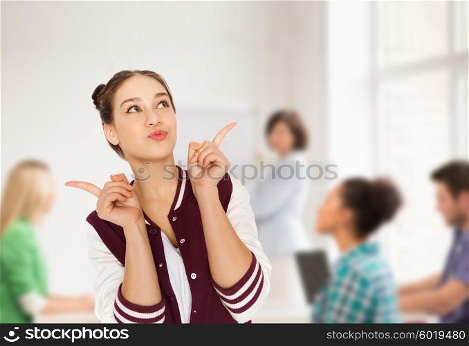 school, education, people and teens concept - happy pretty teenage student girl with eye makeup over classroom background with teacher and classmates