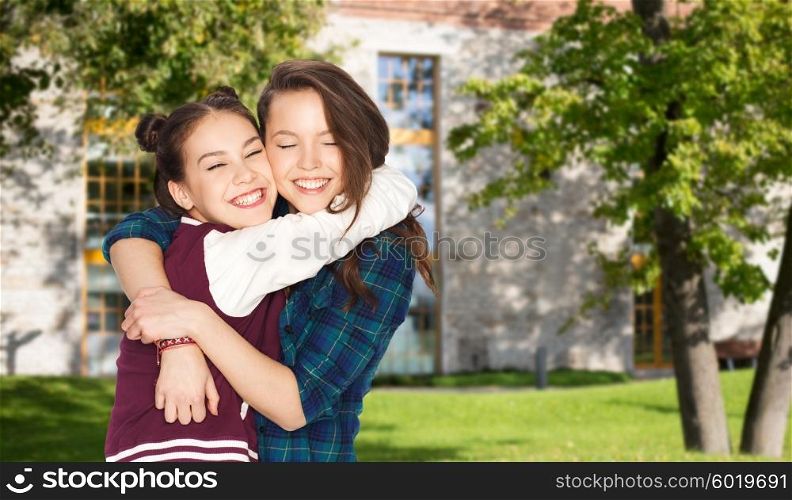 school, education, people, teens and friendship concept - happy smiling pretty teenage student girls hugging over summer campus background