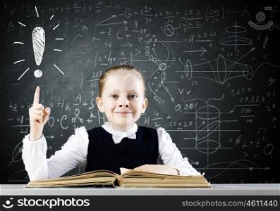 School education. Schoolgirl at lesson with opened book against sketch background