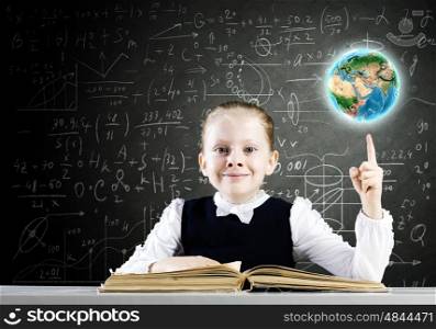 School education. Schoolgirl at lesson with opened book against sketch background. Elements of this image are furnished by NASA