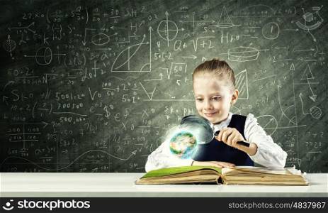 School education. Schoolgirl examining opened book with magnifying glass. Elements of this image are furnished by NASA