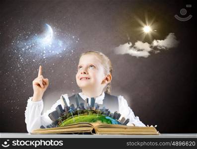 School education. Schoolgirl looking in opened book. Elements of this image are furnished by NASA