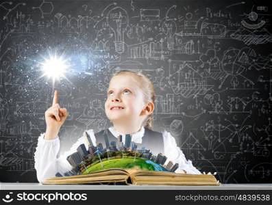 School education. Schoolgirl looking in opened book with sketches at background. Elements of this image are furnished by NASA