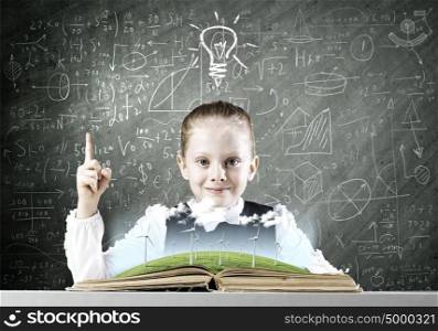 School education. Schoolgirl looking in opened book with sketches at background
