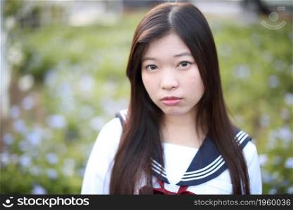 school girl costume at park outdoor with flowers garden background
