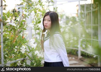school girl costume at park outdoor with flowers garden background