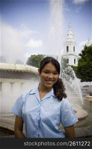 School girl in center plaza by fountain