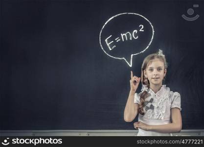 School girl pointing at science formula with finger. Back to school