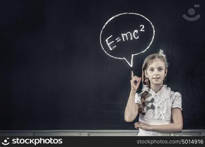 School girl pointing at science formula with finger. Back to school