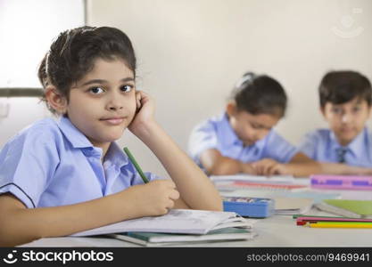 school girl sitting in class and looking at the camera