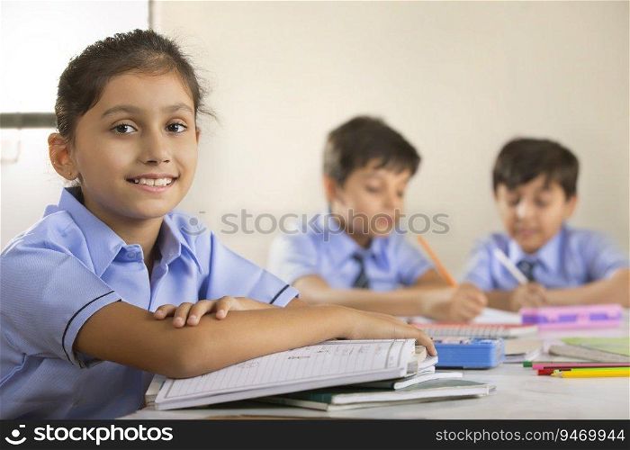 school girl sitting in class and smiling