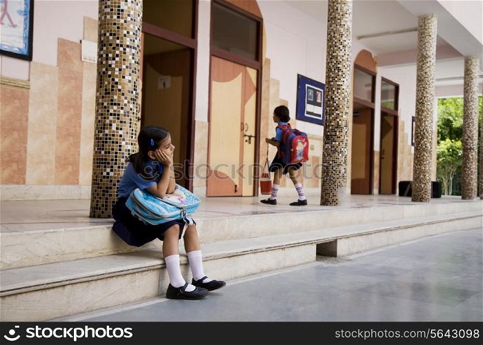 School girl sitting on the steps