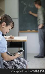 School girl texting in class