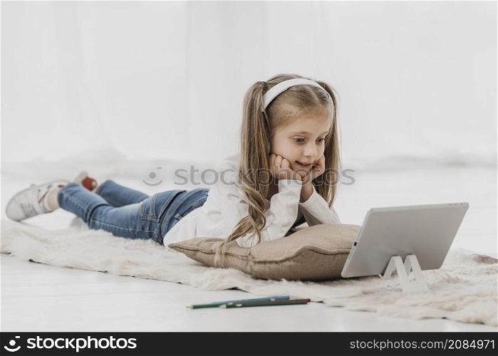 school girl wearing headphones attending online classes
