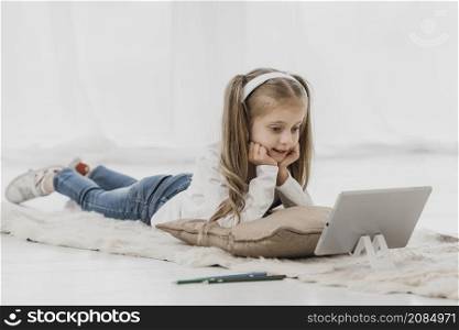 school girl wearing headphones attending online classes