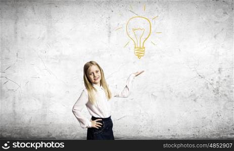School kid. Cute schoolgirl holding electrical bulb in palm
