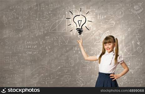 School kid. Cute schoolgirl pointing on electrical bulb with finger