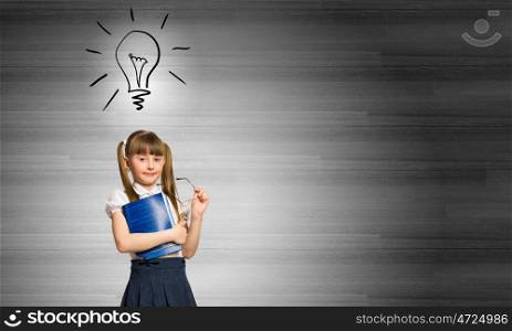 School kid. Cute schoolgirl with glasses and notebook in hands