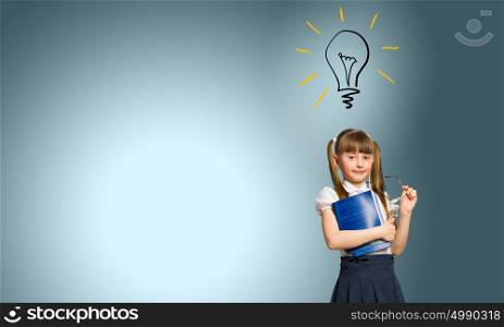 School kid. Cute schoolgirl with glasses and notebook in hands