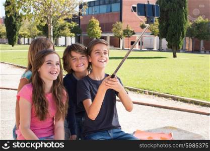 School kids talking photos with a selfie stick