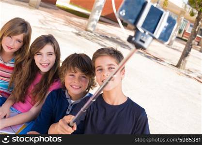 School kids talking photos with a selfie stick