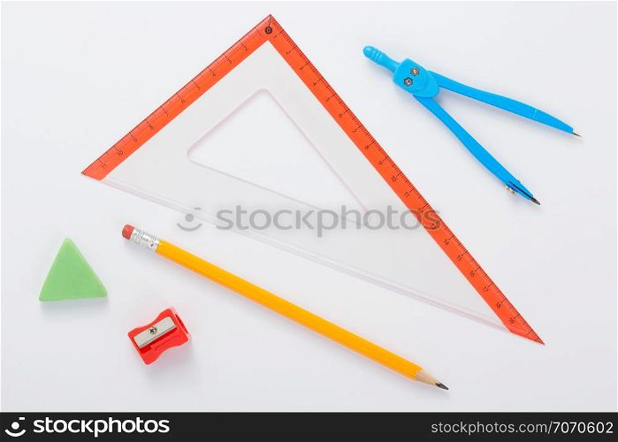 school set and ruler at white background, top view