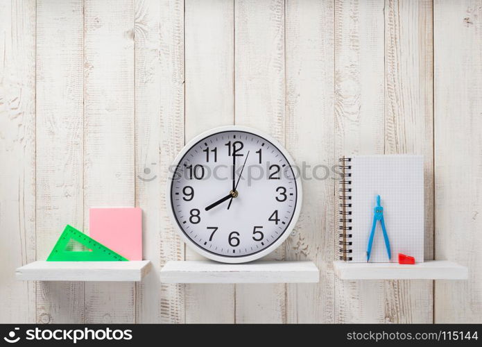 school supplies and tools on white wooden shelf