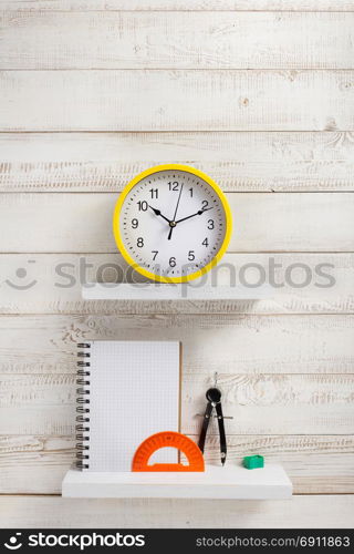 school supplies and tools on white wooden shelf