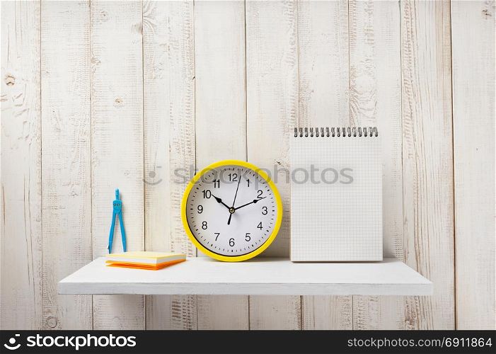 school supplies and tools on white wooden shelf