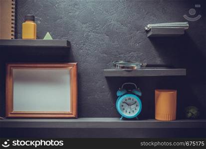school supplies at wooden black wall shelf
