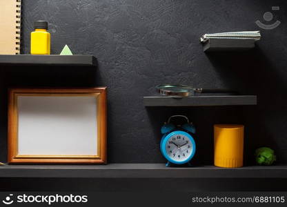 school supplies at wooden black wall shelf