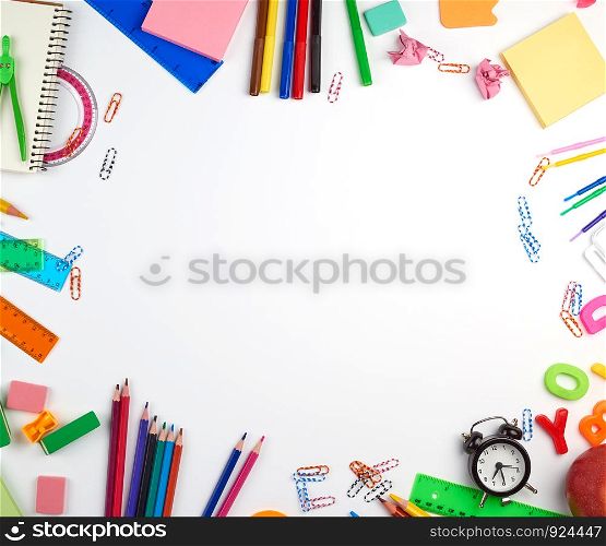 school supplies: multicolored wooden pencils, paper stickers, paper clips, pencil sharpener, copy space, back to school