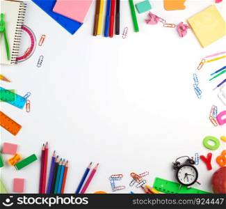school supplies: multicolored wooden pencils, paper stickers, paper clips, pencil sharpener, copy space, back to school