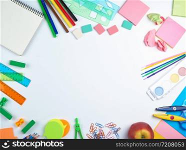 school supplies: multicolored wooden pencils, paper stickers, paper clips, pencil sharpener, copy space